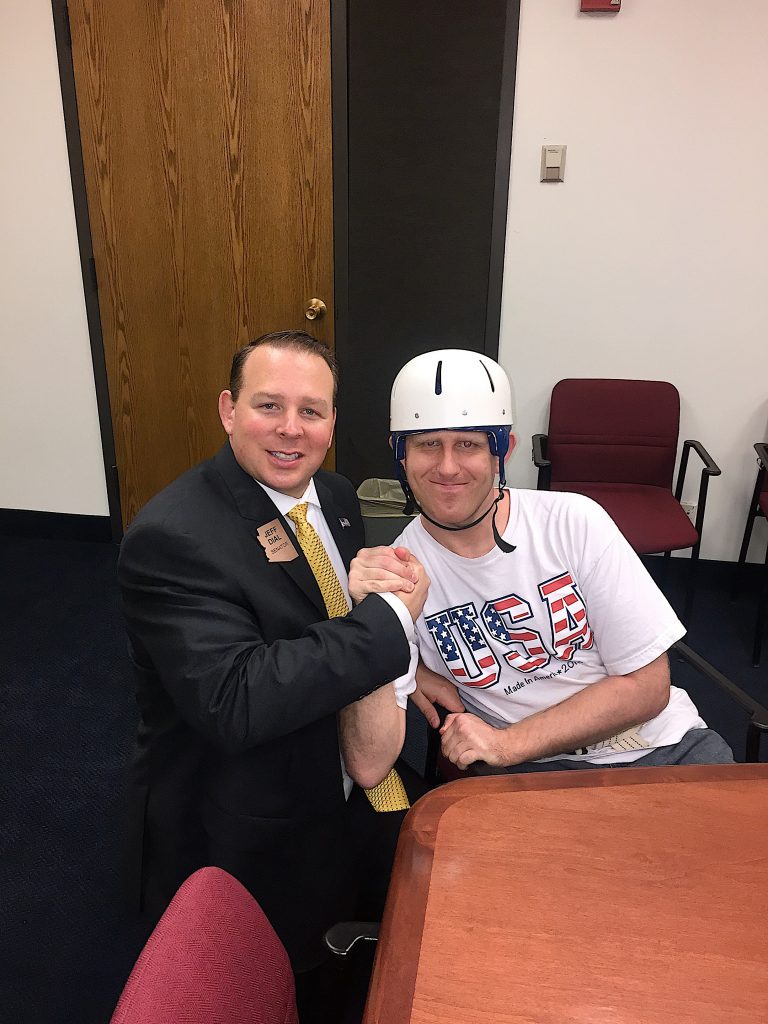 Senator Jeff Dial clasping hands with a constituent at the Arizona State Legislature